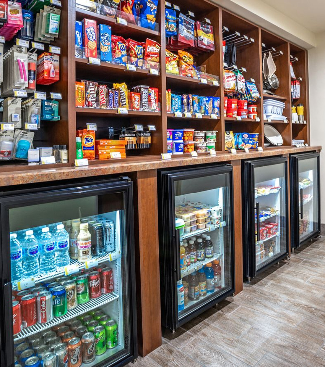 Rows of snacks and toiletries sit above coolers of drinks at the My Store in the lobby at My Place Hotels.