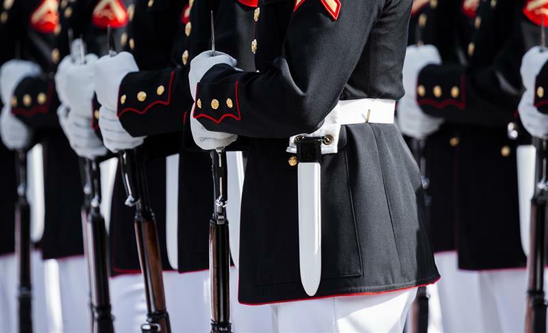 People in military uniform standing in a line.