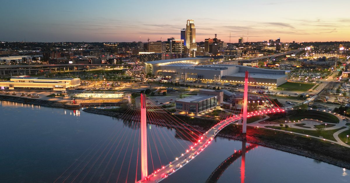 Aerial view of a city with a red glowing bridge