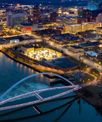 Aerial view of a city in Iowa with a large bridge and river.
