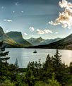 View of mountains and trees that surround a lake.