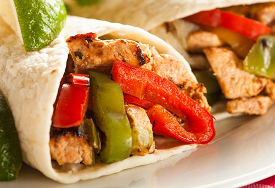 Close view of fajitas stuffed with peppers and chicken.