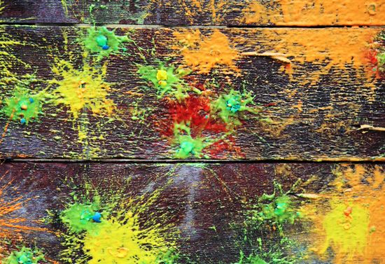 Paint splattered on wood.