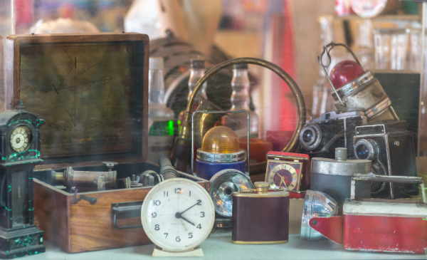 A collection of vintage film items, including old cameras, lights, clocks, and more.