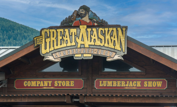 A wooden sign showcasing the Great Alaskan Lumberjack Show