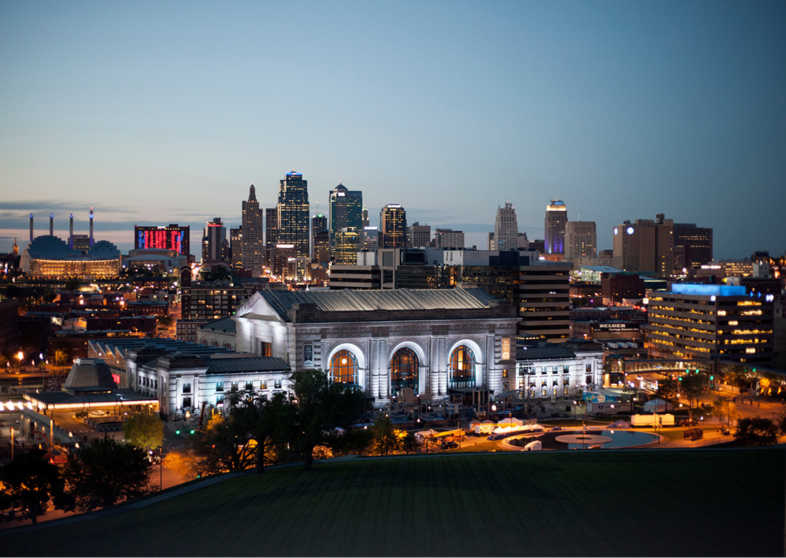 An aerial view of a city's downtown with tall buildings scattering the background.