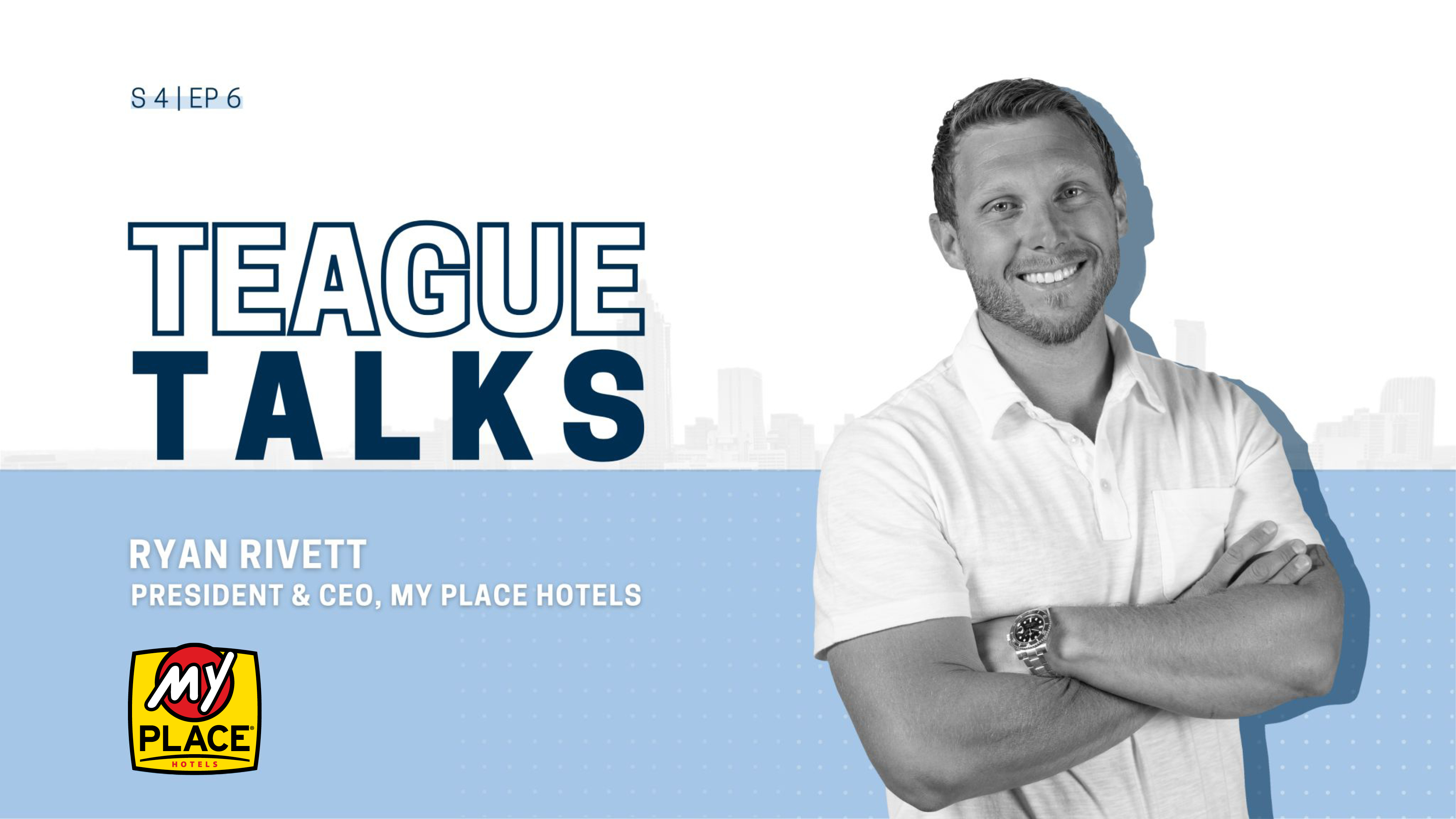 Black and white front view of Ryan Rivett with arms crossed.