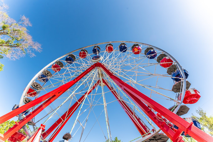 Upward view of a red Ferris wheel.