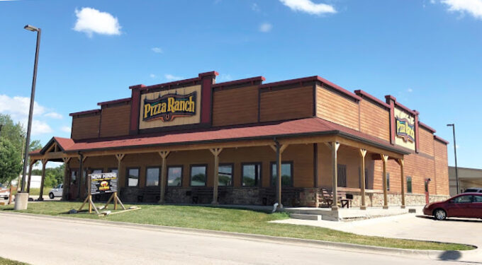 Exterior corner view of a Pizza Ranch building with a classic front-porch style entrance.