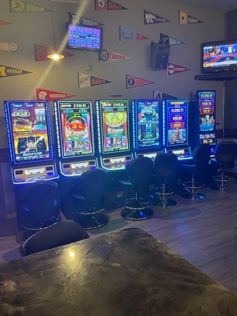 A view of a row of video lottery machines along a bar wall.