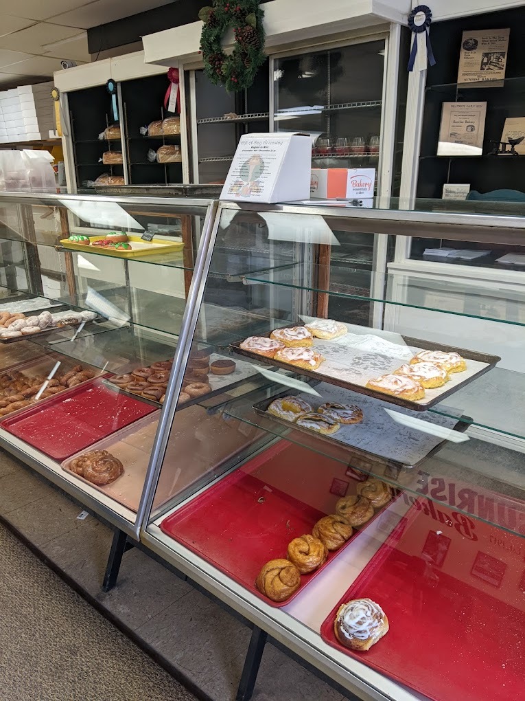 A view of a pastry display case filled with donuts.