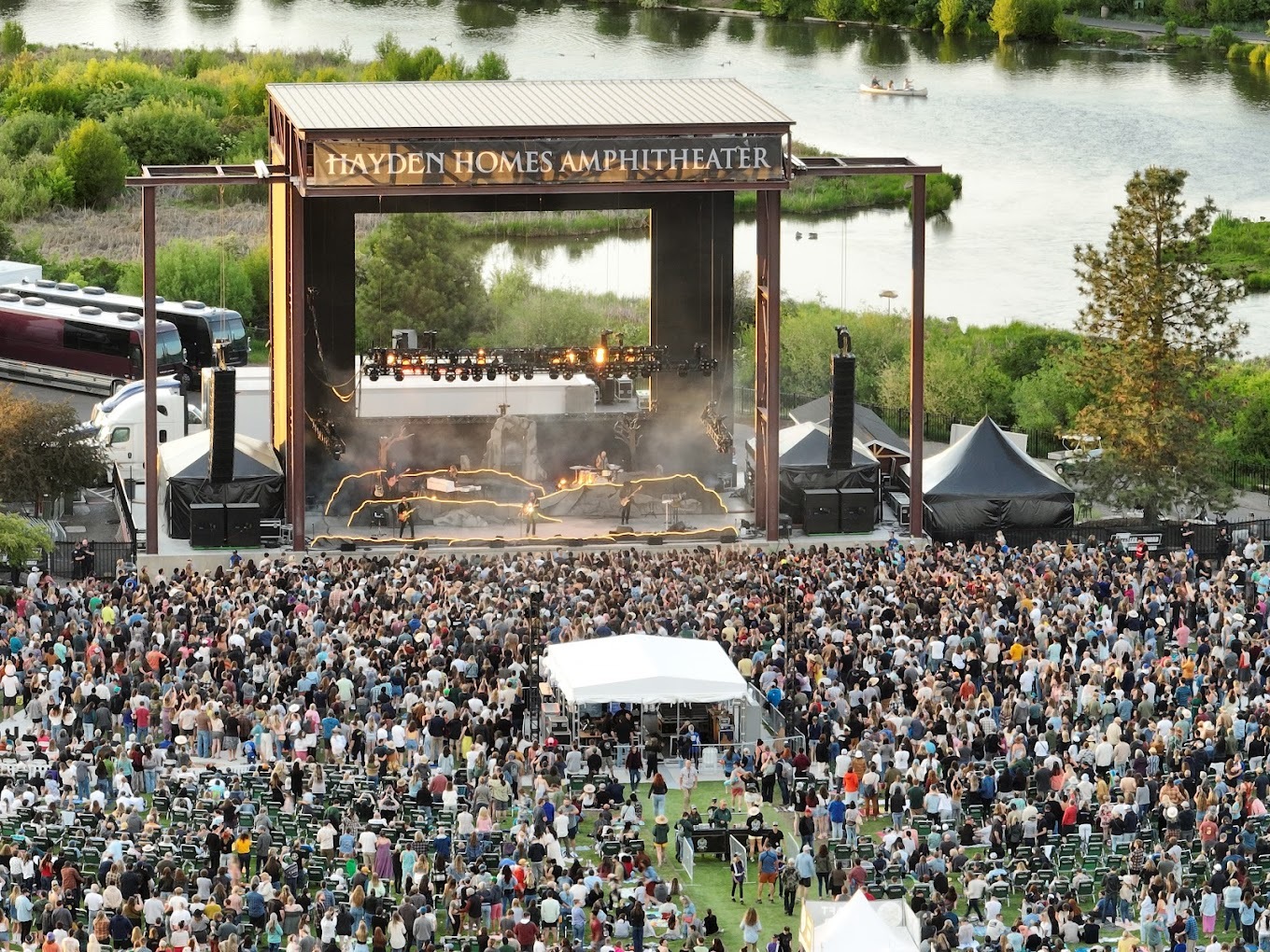 An birds eye view of an Amphitheatre stage, full of attendees in the standing area.