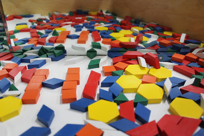 Table with colorful, geometric-shaped blocks.