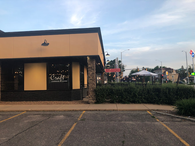An outside view of a restaurant with lots of windows, and lettering in a window with the restaurant logo.