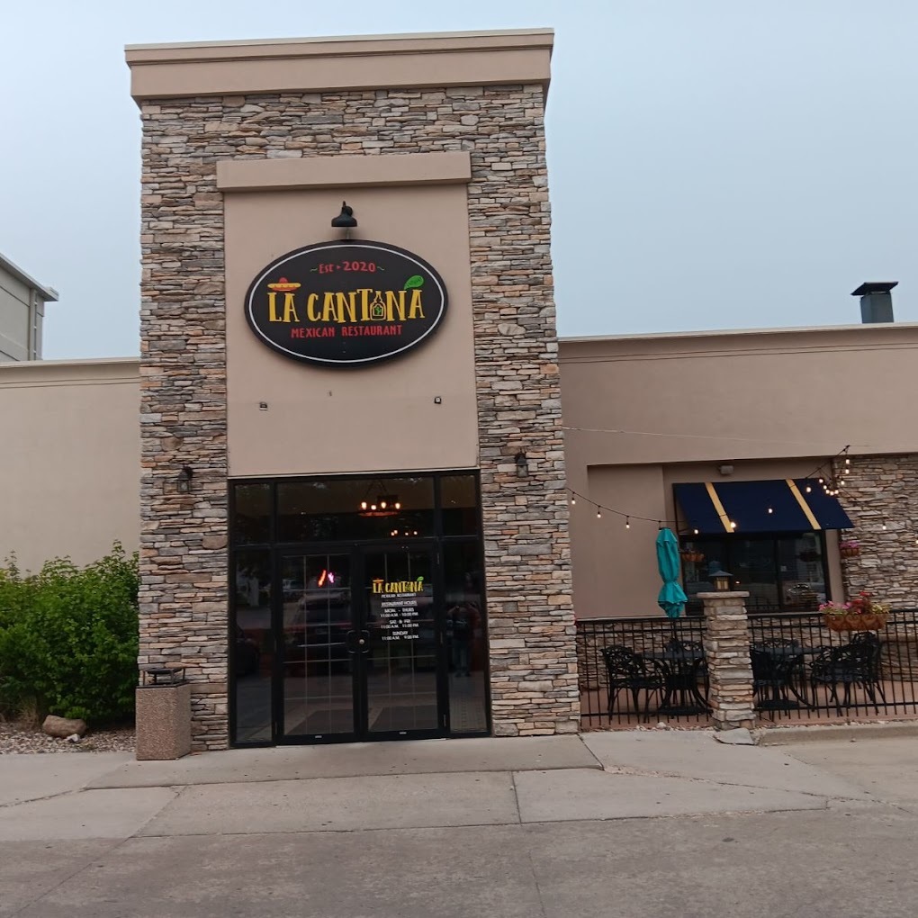An outside view of a restaurant with a black and yellow sign.