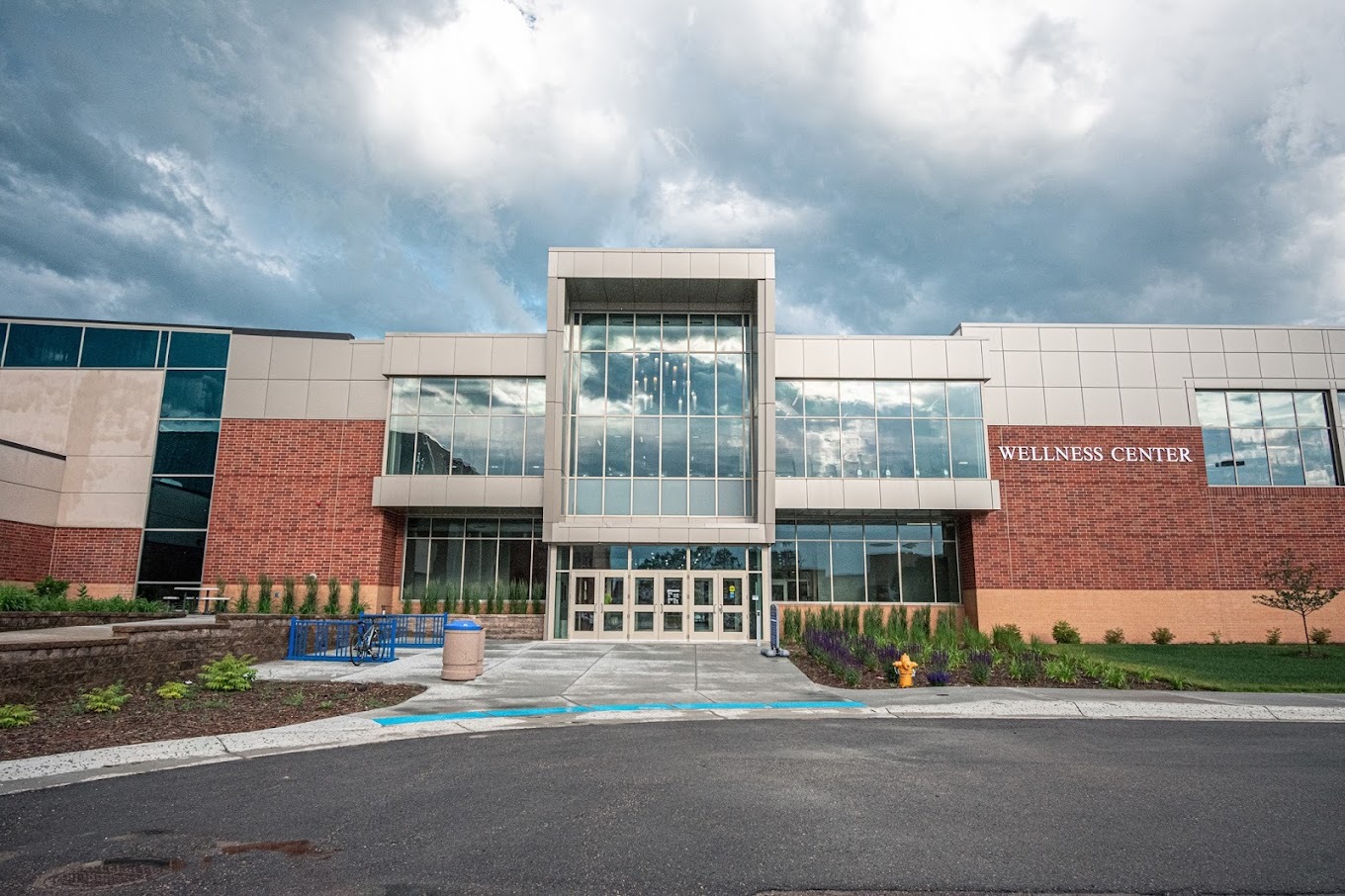 An outside view of a building with a large window section above the building's entrance.