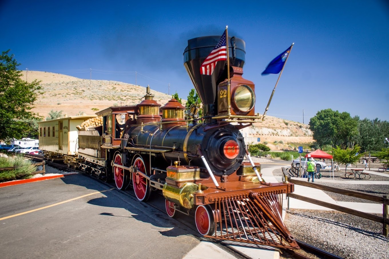 A photo of an old school black and red locomotive.