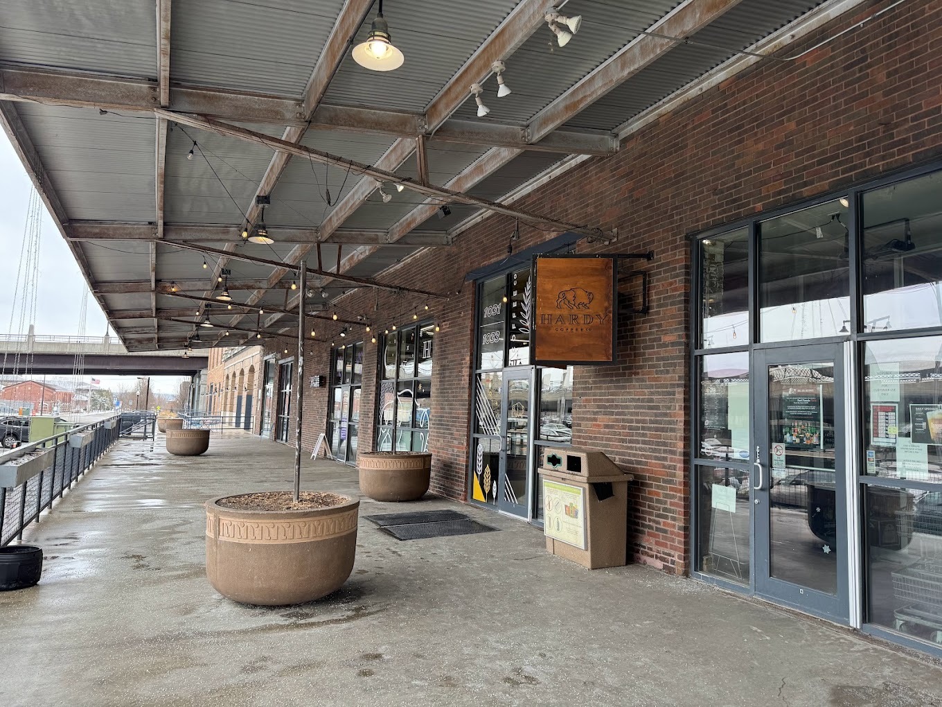 An outside view of a coffee shop, an industrial feel with a row of businesses.