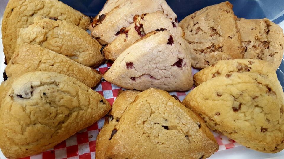 A close up view of a dozen of scones in various sizes and flavors!