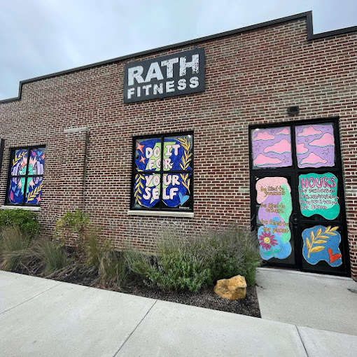 Exterior upward view of a brick building. The windows and doors are covered with colorful uplifting and positive statements.
