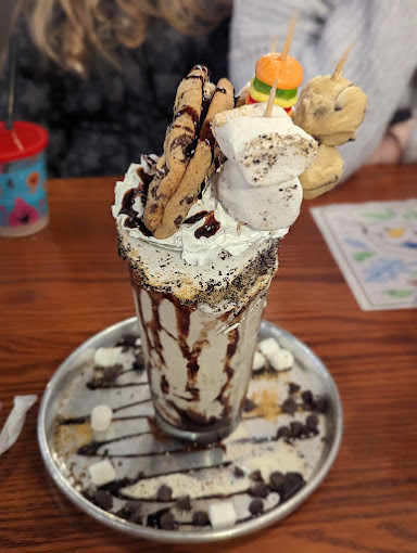 Cookie and chocolate based shake on a steel plate.