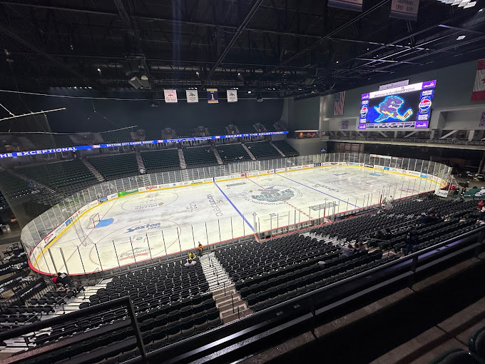 Interior view from the bleachers of an empty  ice rink.