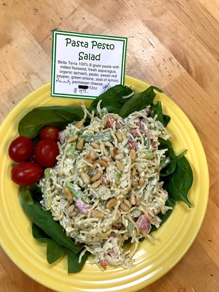 Salad with romaine, pesto, grain pasta, red pepper, green onion and baby tomatoes.