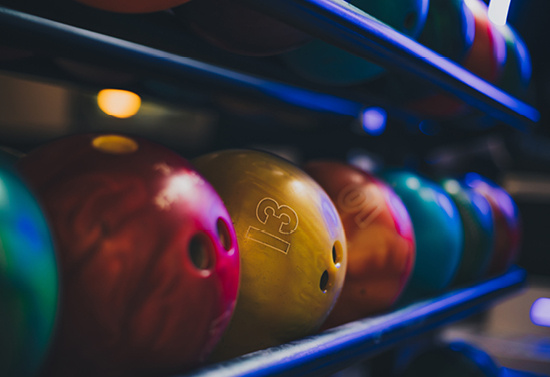 Bowling balls stacked in the bowling storage.