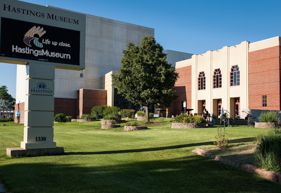 Outside view of the Hastings museum sign and building.