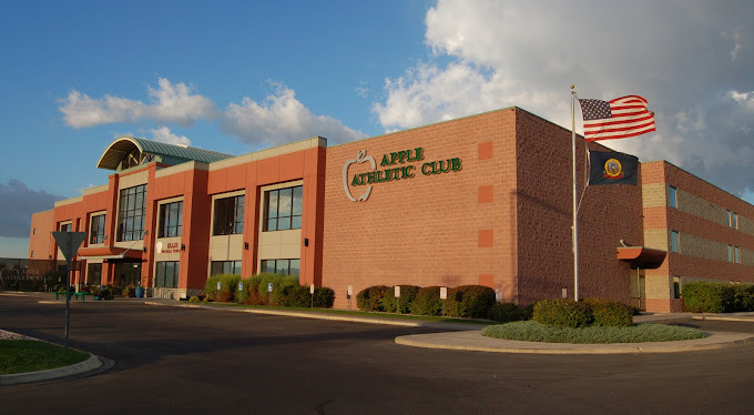 Corner view of the Club Apple building. It is a brown and red brick building with the entrance on the far left of the image.