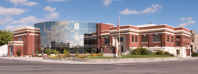 Outside view of Idaho Falls Museum. Circular glass component is on the left side of the building, with the rest being brick.