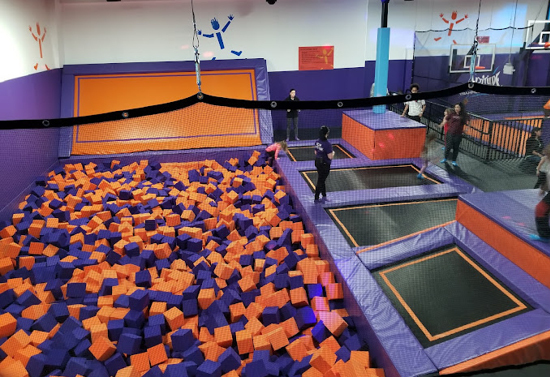 Floor trampolines on the right. Purple and orange foam square ball pit is on the left.