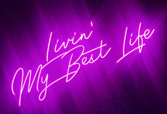 Purple neon sign that states "Livin' My Best Life."