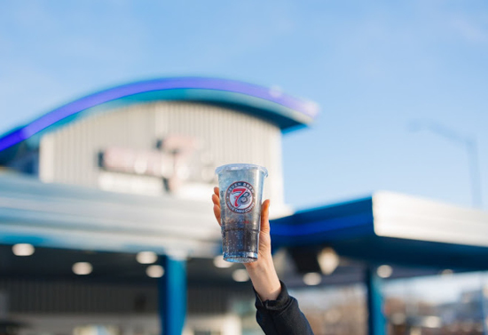 Hand holding a blue drink. Photo with shallow depth of field.