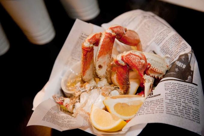 Shrimp and lemons in a newspaper lined basket.