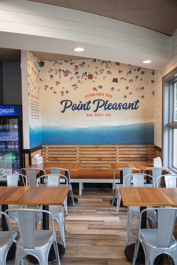 An inside view of a sitting area inside of a Jersey Mikes.