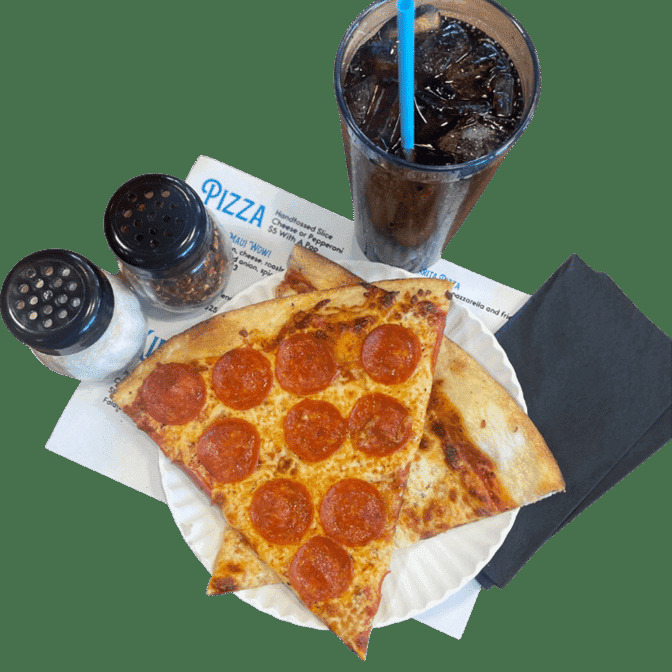 A view of a pizza on a plate on a green background with a soda on the side with salt and paprika shakers.
