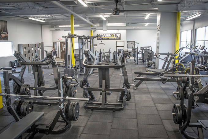 An inside view of a gym with workout equipment filling the room.