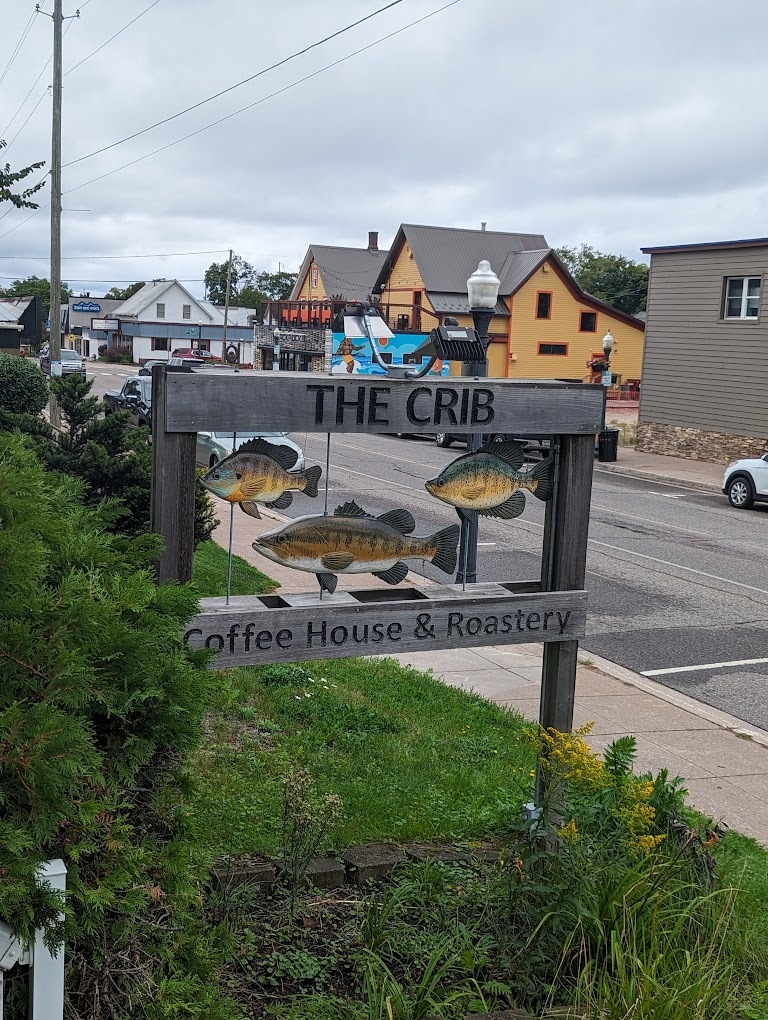 A outside view of a sign to a shop.