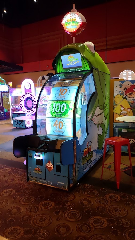 A view of an arcade and a view of a kids slot machine.