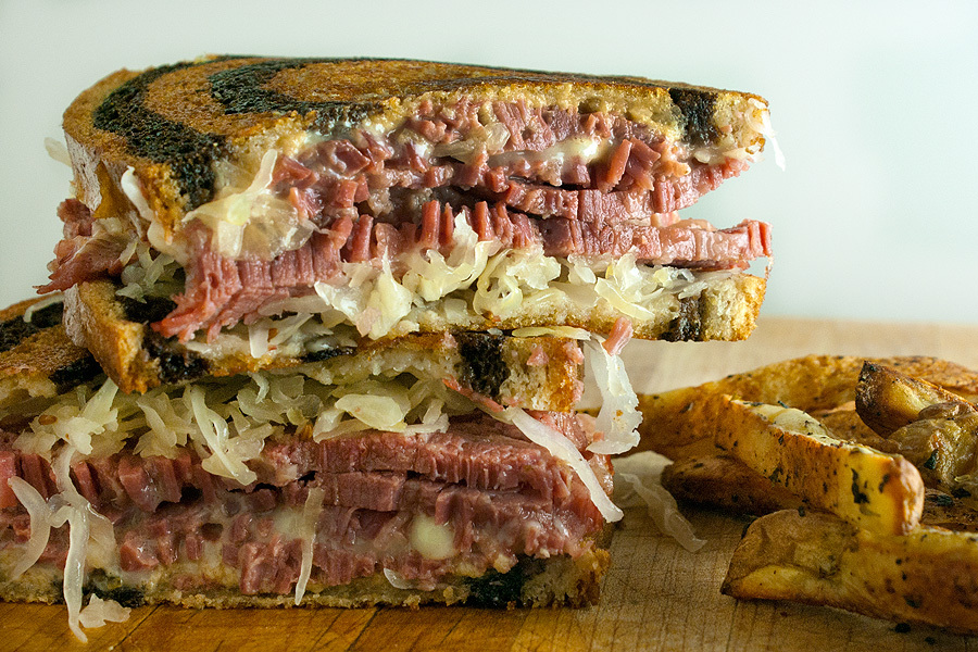 Grilled sandwich with meat, lettuce and onion.
