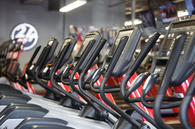 Close view of neatly lined up red and black workout equipment.