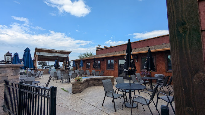 An outside view of a patio seating area, complete with a covered stage.