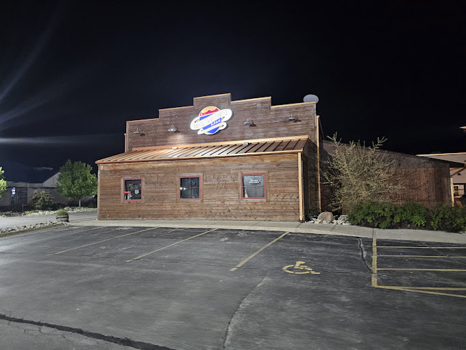 An outside view of a brick building with a large white sign on the side of the building.