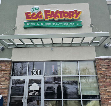 Red and green "Egg Factory" logo with a slat sunshade and glass doors underneath.