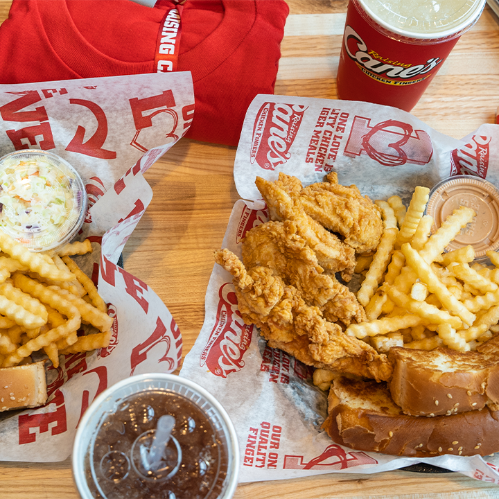 A view of two chicken strip baskets, one with a side of coleslaw and fries, and toast and fries with the other tender meal.