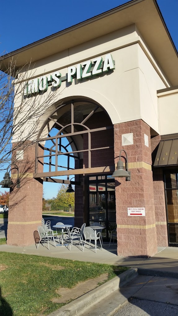 A crème and brown colored building with "Imo's Pizza" signage on the building in white lettering.