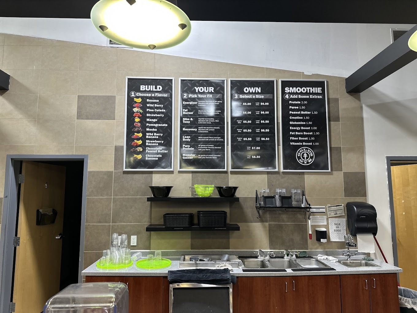 A view of a smoothie and protein shake bar, with a four panel menu.