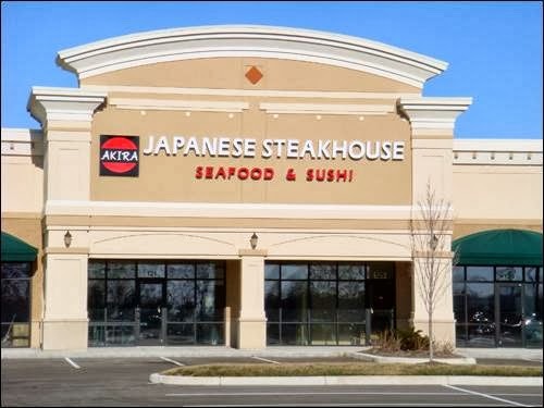 Large beige building with columns and a sign that reads "Japanese Steakhouse" in white lettering, with "Seafood and Sushi" in red lettering underneath.