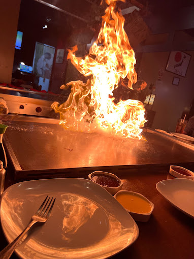 Close view of a flame on a table side cooking experience.